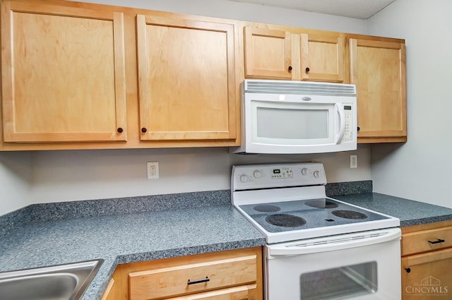 10350 W Rd Unit 34, Harrison, OH 45030 - kitchen featuring white appliances, light brown cabinets, dark countertops, and a sink