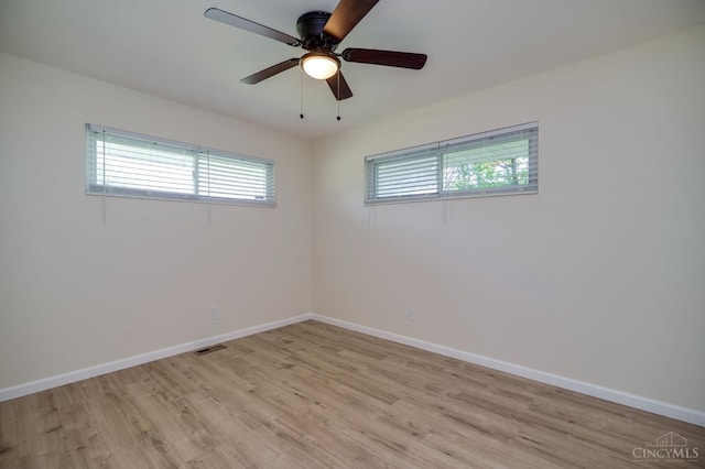2389 Aquarius Dr, Springfield Twp, OH 45231 - empty room with healthy amount of natural light, light wood-type flooring, and baseboards