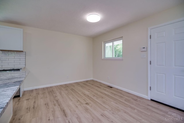 2389 Aquarius Dr, Springfield Twp, OH 45231 - unfurnished living room featuring light wood finished floors and baseboards