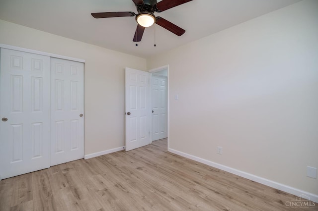 2389 Aquarius Dr, Springfield Twp, OH 45231 - unfurnished bedroom with light wood finished floors, baseboards, a closet, and ceiling fan