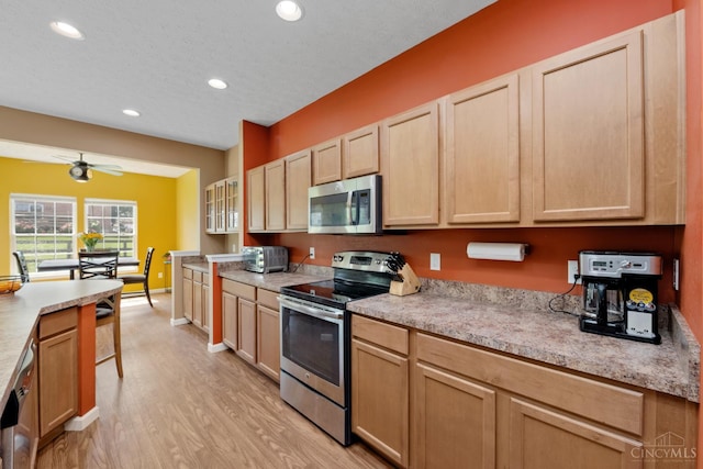 164 Shanda Dr, Monroe, OH 45040 - kitchen with stainless steel appliances, light brown cabinets, light wood finished floors, recessed lighting, and light countertops