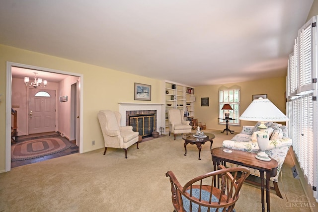 667 N Meadowcrest Cir, Springfield Twp, OH 45231 - carpeted living area with a chandelier and a fireplace with flush hearth