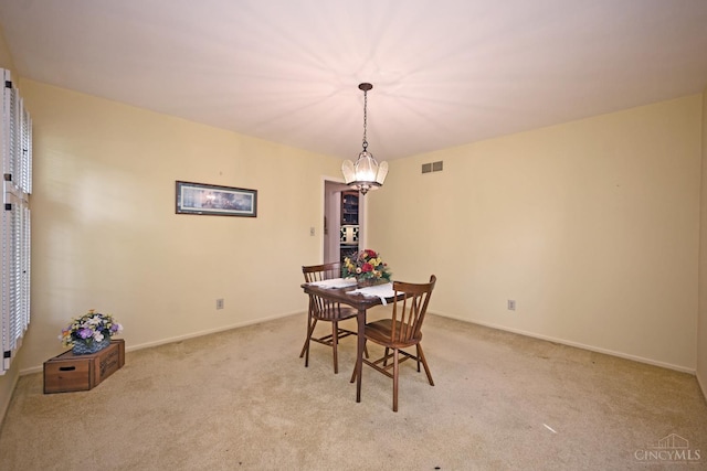 667 N Meadowcrest Cir, Springfield Twp, OH 45231 - dining room featuring light carpet, a chandelier, and baseboards