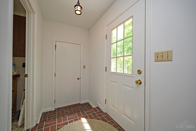 667 N Meadowcrest Cir, Springfield Twp, OH 45231 - doorway to outside with brick patterned floors and baseboards