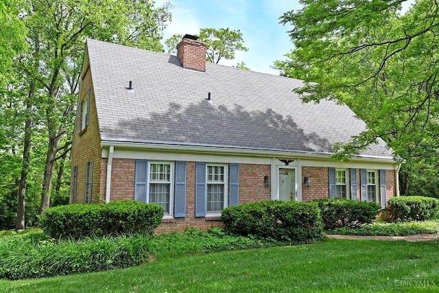 667 N Meadowcrest Cir, Springfield Twp, OH 45231 - cape cod home featuring a chimney, brick siding, a front yard, and a shingled roof