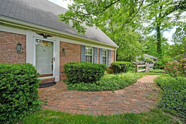 667 N Meadowcrest Cir, Springfield Twp, OH 45231 - view of exterior entry with brick siding and roof with shingles
