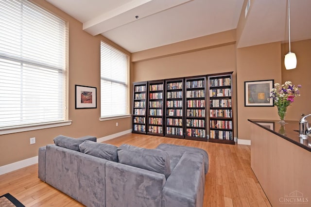 15 W Fourth St Unit 413, Cincinnati, OH 45202 - living room with light wood-style flooring, baseboards, and beam ceiling