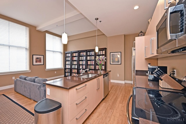 15 W Fourth St Unit 413, Cincinnati, OH 45202 - kitchen with appliances with stainless steel finishes, a sink, light wood-type flooring, baseboards, and pendant lighting