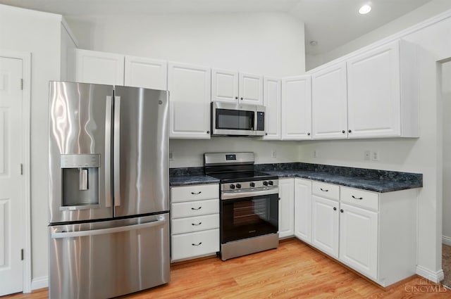 7785 Dew Drop Cir, Hamilton Twp, OH 45039 - kitchen featuring appliances with stainless steel finishes, white cabinetry, light wood-style floors, lofted ceiling, and recessed lighting
