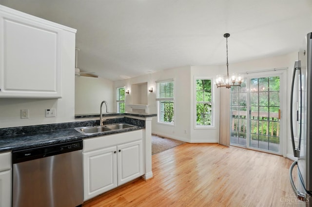 7785 Dew Drop Cir, Hamilton Twp, OH 45039 - kitchen with stainless steel appliances, a sink, dark countertops, and a chandelier