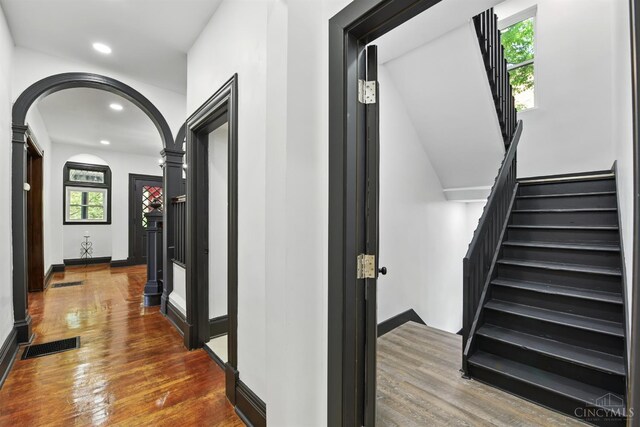 752 S Fred Shuttlesworth Cir, Cincinnati, OH 45229 - hallway featuring arched walkways, wood finished floors, recessed lighting, stairs, and baseboards