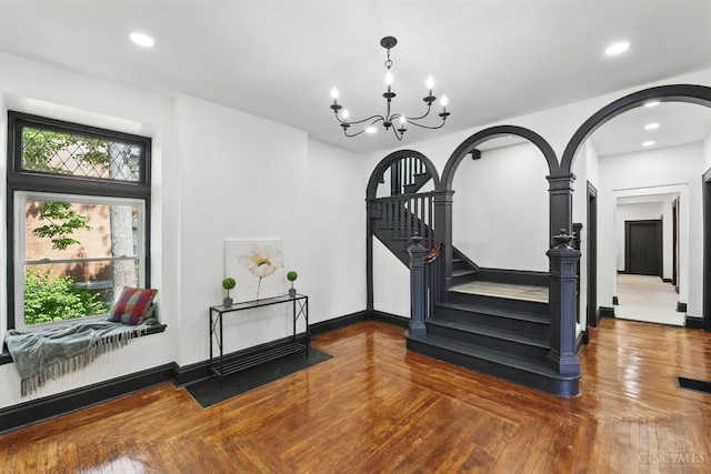 752 S Fred Shuttlesworth Cir, Cincinnati, OH 45229 - stairs featuring arched walkways, a chandelier, recessed lighting, baseboards, and parquet flooring