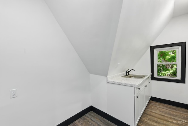 752 S Fred Shuttlesworth Cir, Cincinnati, OH 45229 - bathroom featuring a sink, lofted ceiling, wood finished floors, and baseboards