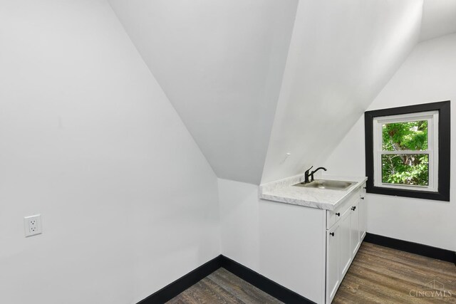 752 S Fred Shuttlesworth Cir, Cincinnati, OH 45229 - bathroom featuring a sink, lofted ceiling, wood finished floors, and baseboards