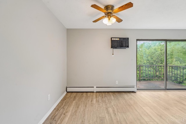 6644 Hearne Rd Unit 202, Green Twp, OH 45248 - spare room featuring a baseboard radiator, wood finished floors, a wall unit AC, a ceiling fan, and baseboards