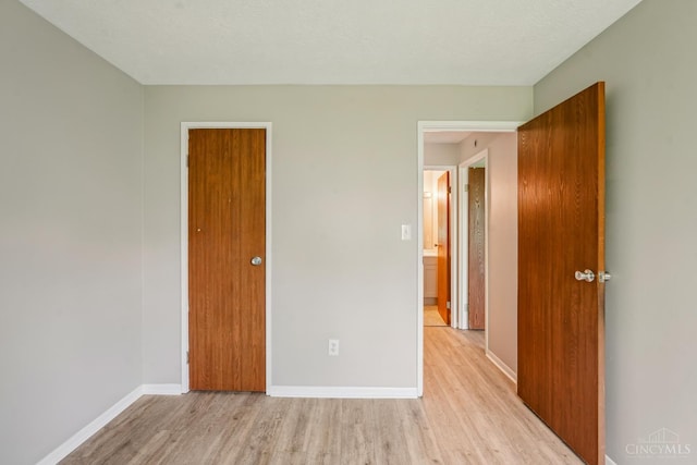 6644 Hearne Rd Unit 202, Green Twp, OH 45248 - unfurnished bedroom featuring light wood finished floors and baseboards