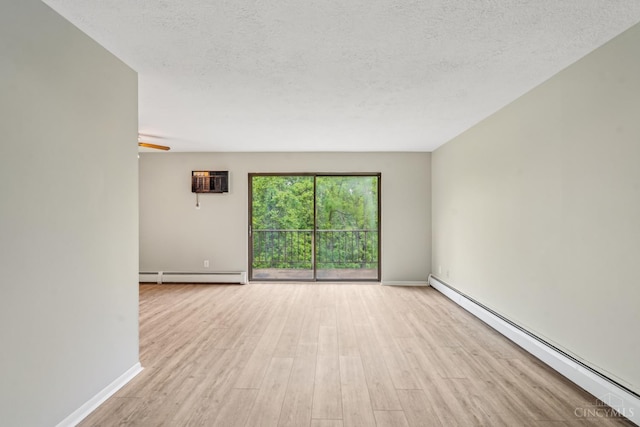 6644 Hearne Rd Unit 202, Green Twp, OH 45248 - unfurnished room with a baseboard heating unit, wood finished floors, a wall mounted air conditioner, baseboards, and a textured ceiling
