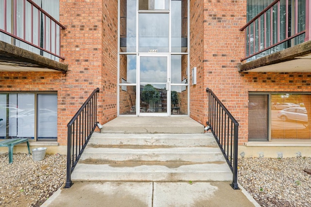 6644 Hearne Rd Unit 202, Green Twp, OH 45248 - doorway to property with brick siding and a balcony