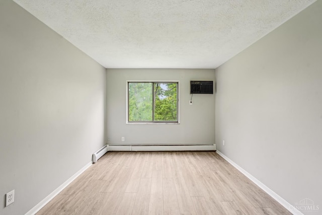 6644 Hearne Rd Unit 202, Green Twp, OH 45248 - empty room with wood finished floors, an AC wall unit, a baseboard heating unit, a textured ceiling, and baseboards