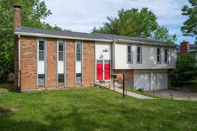 11909 Blackhawk Cir, Springfield Twp, OH 45240 - bi-level home with a chimney, an attached garage, a front yard, brick siding, and driveway