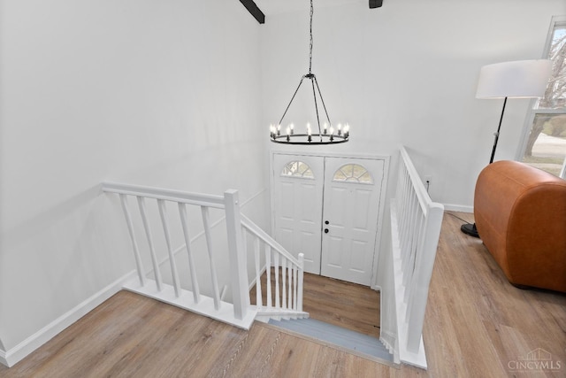 11909 Blackhawk Cir, Springfield Twp, OH 45240 - entrance foyer with wood finished floors, a chandelier, and baseboards