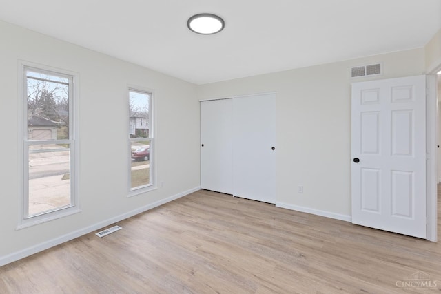 11909 Blackhawk Cir, Springfield Twp, OH 45240 - unfurnished bedroom with light wood finished floors, baseboards, and a closet