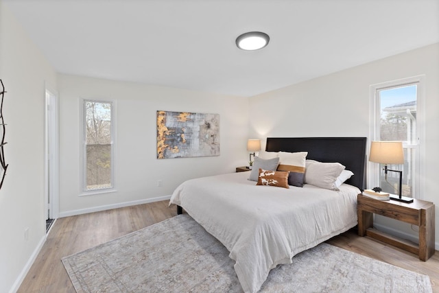 11909 Blackhawk Cir, Springfield Twp, OH 45240 - bedroom with multiple windows, light wood-type flooring, and baseboards