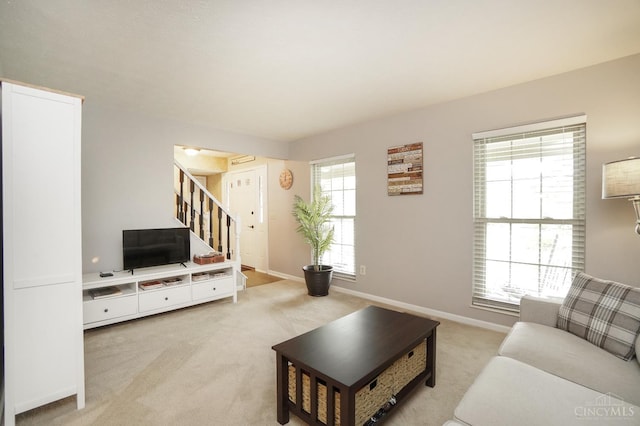 5509 Windmere Dr, Green Twp, OH 45248 - living room featuring light carpet, stairs, and baseboards