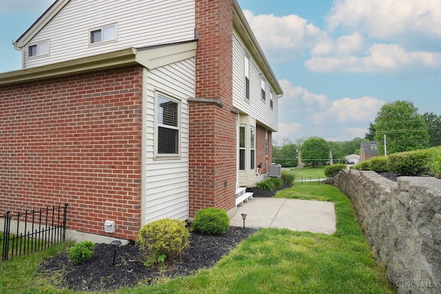 5509 Windmere Dr, Green Twp, OH 45248 - view of side of property featuring brick siding and a patio