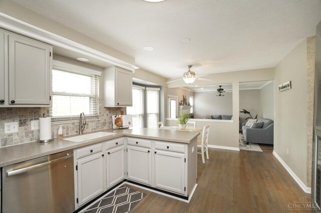 5509 Windmere Dr, Green Twp, OH 45248 - kitchen with a sink, dishwasher, decorative backsplash, and a peninsula