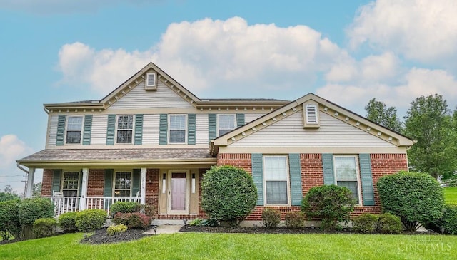 5509 Windmere Dr, Green Twp, OH 45248 - view of front of home featuring brick siding, a front lawn, and a porch