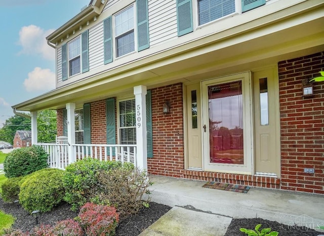 5509 Windmere Dr, Green Twp, OH 45248 - view of exterior entry with brick siding and covered porch