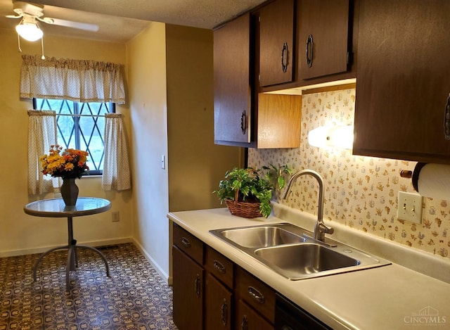9521 Haddington Ct, Colerain Twp, OH 45251 - kitchen featuring a sink, light countertops, baseboards, a ceiling fan, and dark brown cabinetry