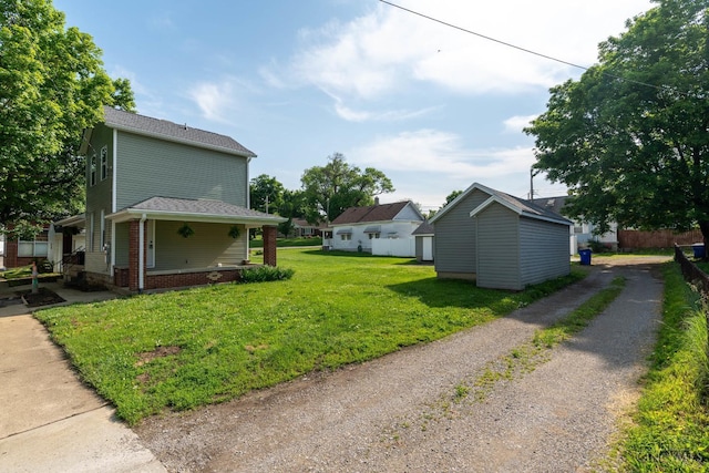 926 Shuler Ave, Hamilton, OH 45011 - view of green lawn with gravel driveway and an outbuilding