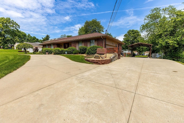 1366 Devils Backbone Rd, Green Twp, OH 45233 - view of front of property with concrete driveway, brick siding, a detached carport, and a front yard