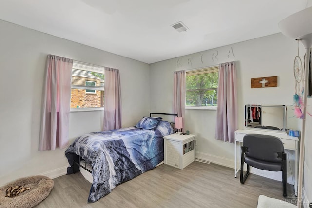 1366 Devils Backbone Rd, Green Twp, OH 45233 - bedroom featuring multiple windows, light wood-style floors, and baseboards