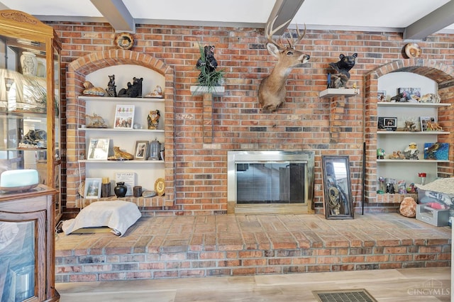 1366 Devils Backbone Rd, Green Twp, OH 45233 - living area featuring beam ceiling and a brick fireplace