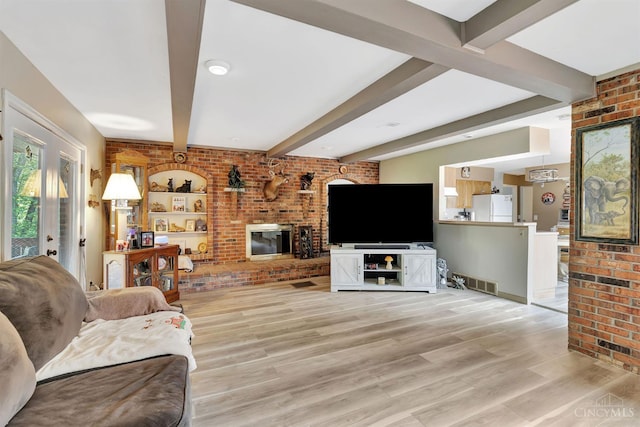 1366 Devils Backbone Rd, Green Twp, OH 45233 - living area with brick wall, beam ceiling, light wood finished floors, and a brick fireplace