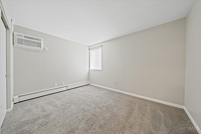 4906 Chalet Dr Unit 7, Saint Bernard, OH 45217 - carpeted empty room with a baseboard radiator and a wall mounted air conditioner