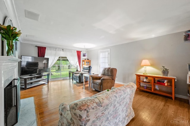 200 Santa Fe Rd, Middletown, OH 45042 - living area with wood finished floors, ornamental molding, and a fireplace
