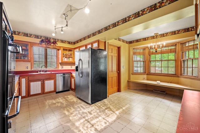 200 Santa Fe Rd, Middletown, OH 45042 - kitchen with appliances with stainless steel finishes, light flooring, a chandelier, and glass insert cabinets