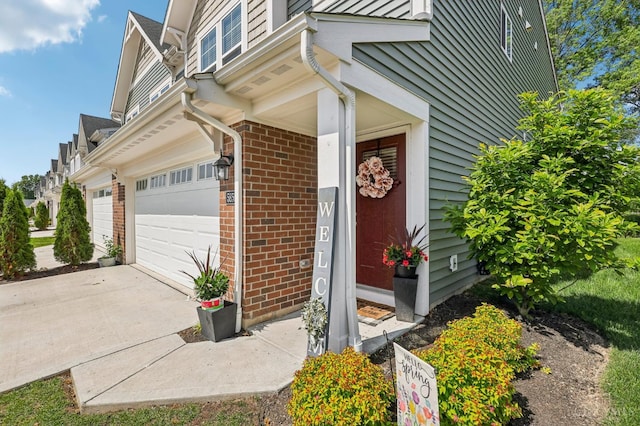 5859 Parkview Ln, Miami Twp, OH 45150 - view of exterior entry with brick siding, driveway, and a garage