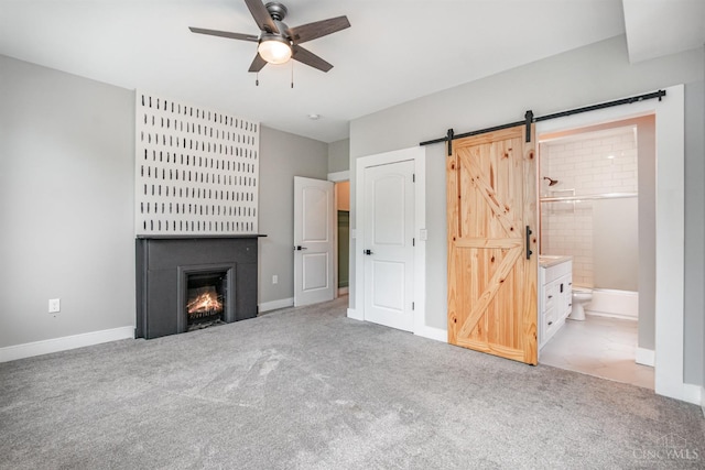 4226 Chambers St, Cincinnati, OH 45223 - unfurnished bedroom with a barn door, carpet, a lit fireplace, baseboards, and ensuite bathroom
