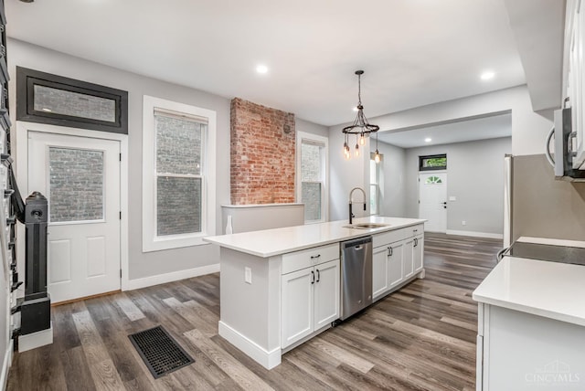 4226 Chambers St, Cincinnati, OH 45223 - kitchen featuring stainless steel appliances, a sink, dark wood finished floors, light countertops, and recessed lighting