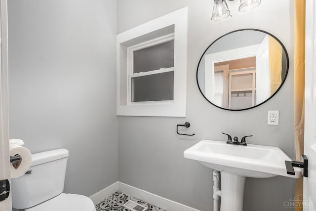 4226 Chambers St, Cincinnati, OH 45223 - bathroom with baseboards, toilet, and a sink
