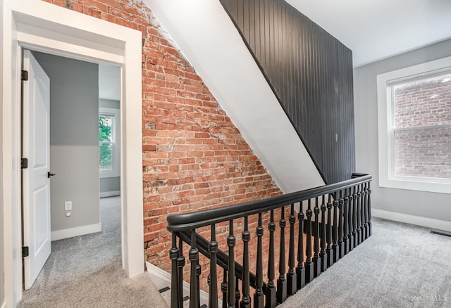 4226 Chambers St, Cincinnati, OH 45223 - hallway with carpet flooring, an upstairs landing, brick wall, and baseboards