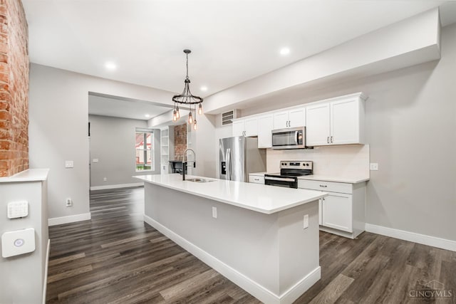 4226 Chambers St, Cincinnati, OH 45223 - kitchen with appliances with stainless steel finishes, a sink, dark wood-style flooring, recessed lighting, and white cabinetry
