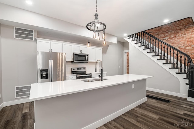 4226 Chambers St, Cincinnati, OH 45223 - kitchen featuring stainless steel appliances, a sink, baseboards, dark wood finished floors, and white cabinets