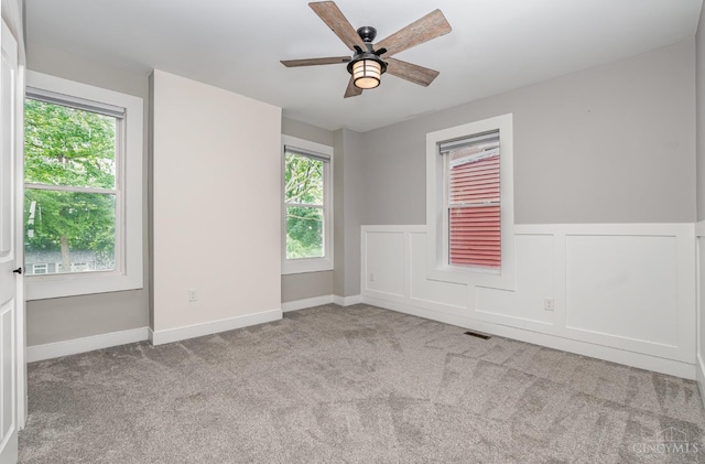 4226 Chambers St, Cincinnati, OH 45223 - unfurnished room featuring healthy amount of natural light, ceiling fan, carpet flooring, and a wainscoted wall