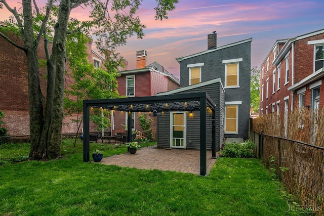 4226 Chambers St, Cincinnati, OH 45223 - back of property at dusk with brick siding, a gazebo, a chimney, and a patio area